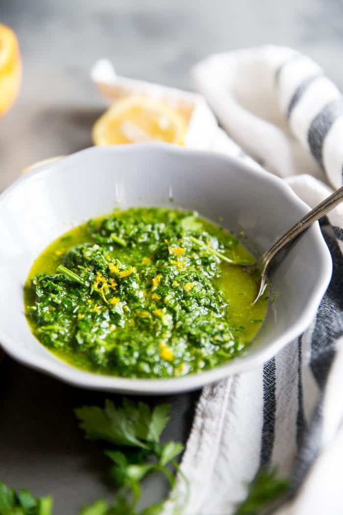 Bowl of chimichurri sauce with spoon