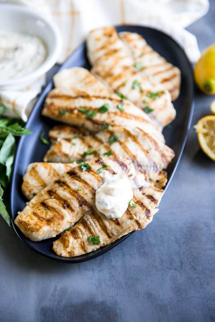 Grilled tilapia on platter with aioli