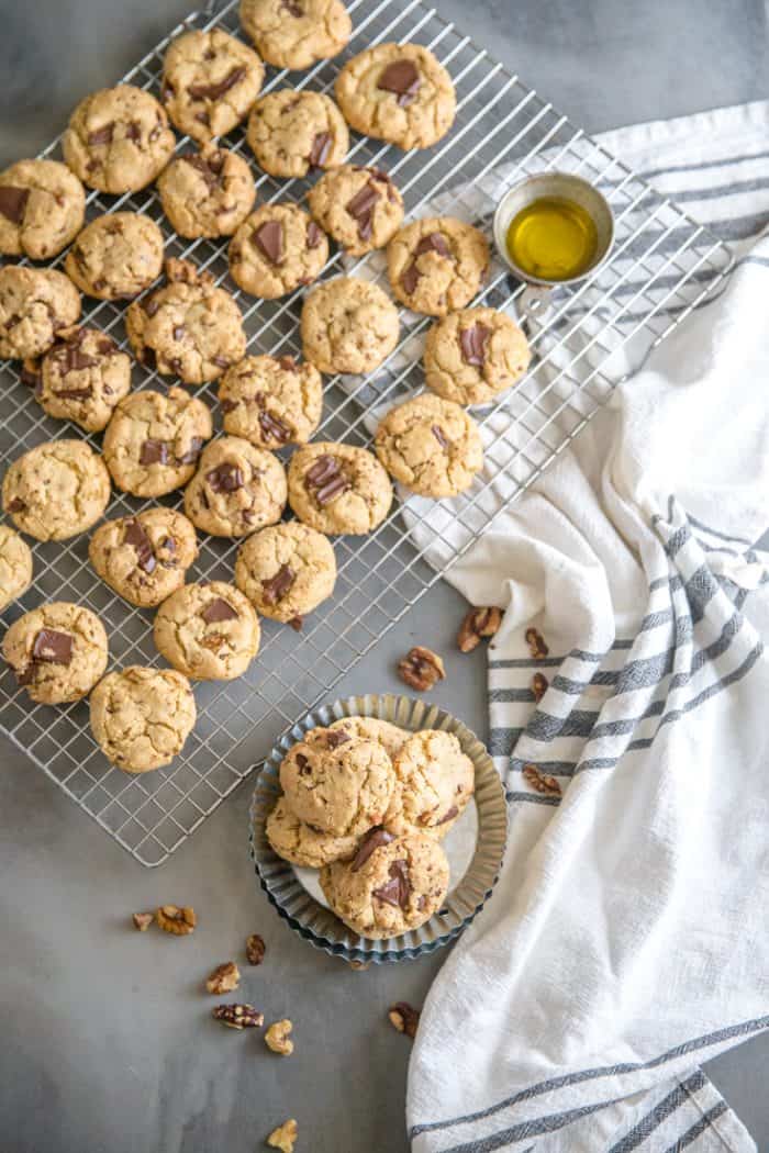 chocolate chip walnut cookies on a dish and baking rack