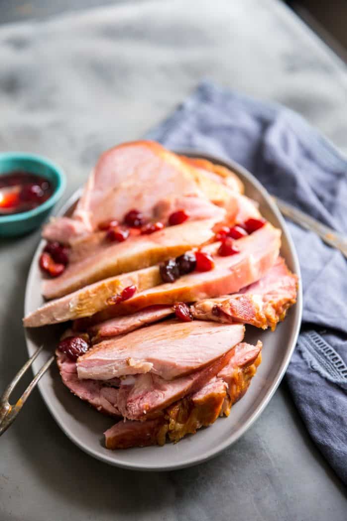 Sliced baked ham on gray platter