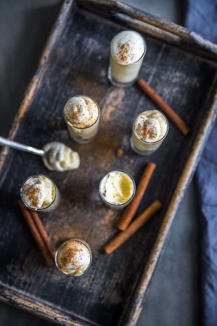 Pudding shots on a tray with a spoon