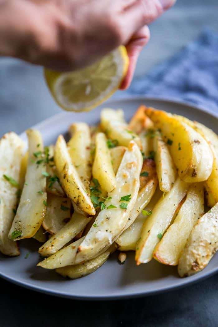 Greek roasted potatoes with a squeeze of lemon