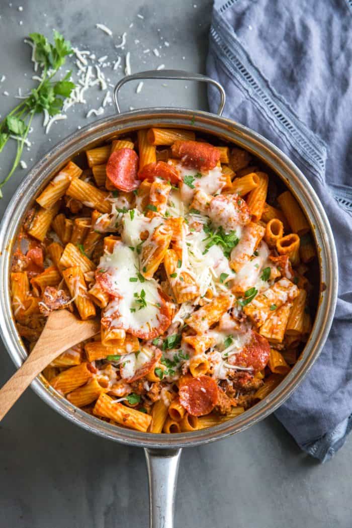Pizza pasta with spoon is skillet