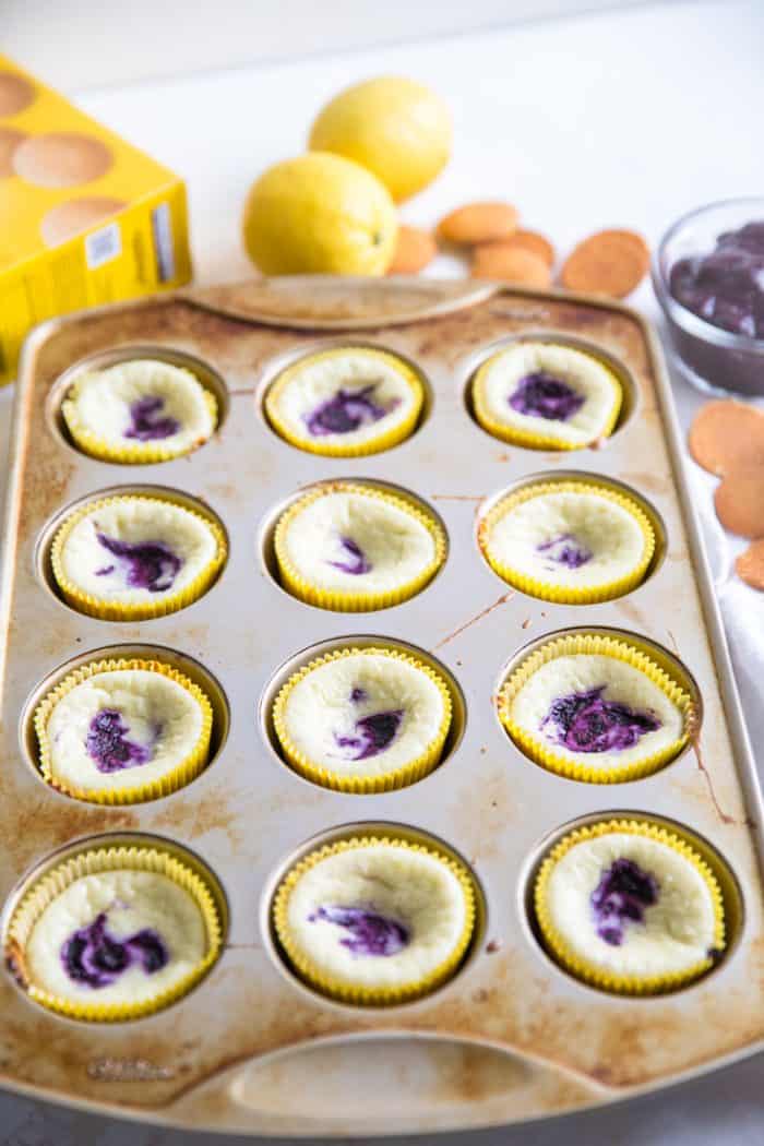 baked blueberry cheesecakes in muffin tin