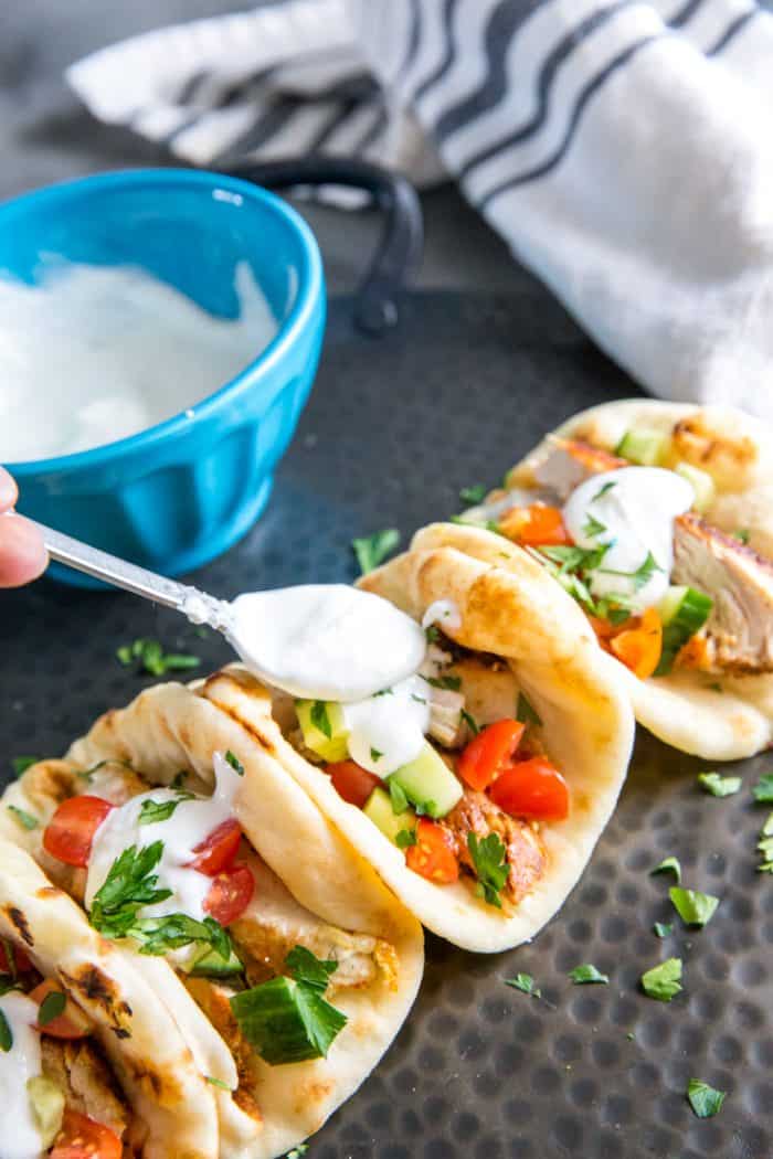 chicken gyro with spoon and sauce