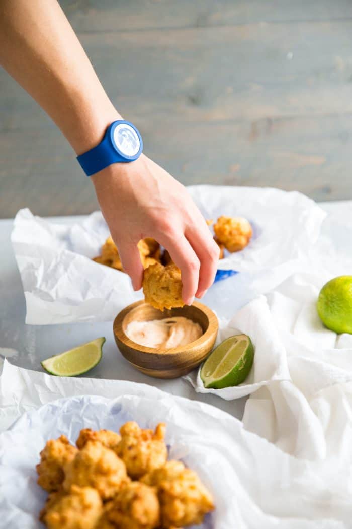 Hand dipping conch fritters