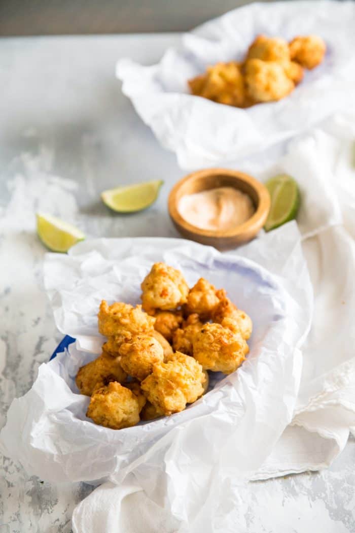 conch fritters with a bowl fo dip on the side