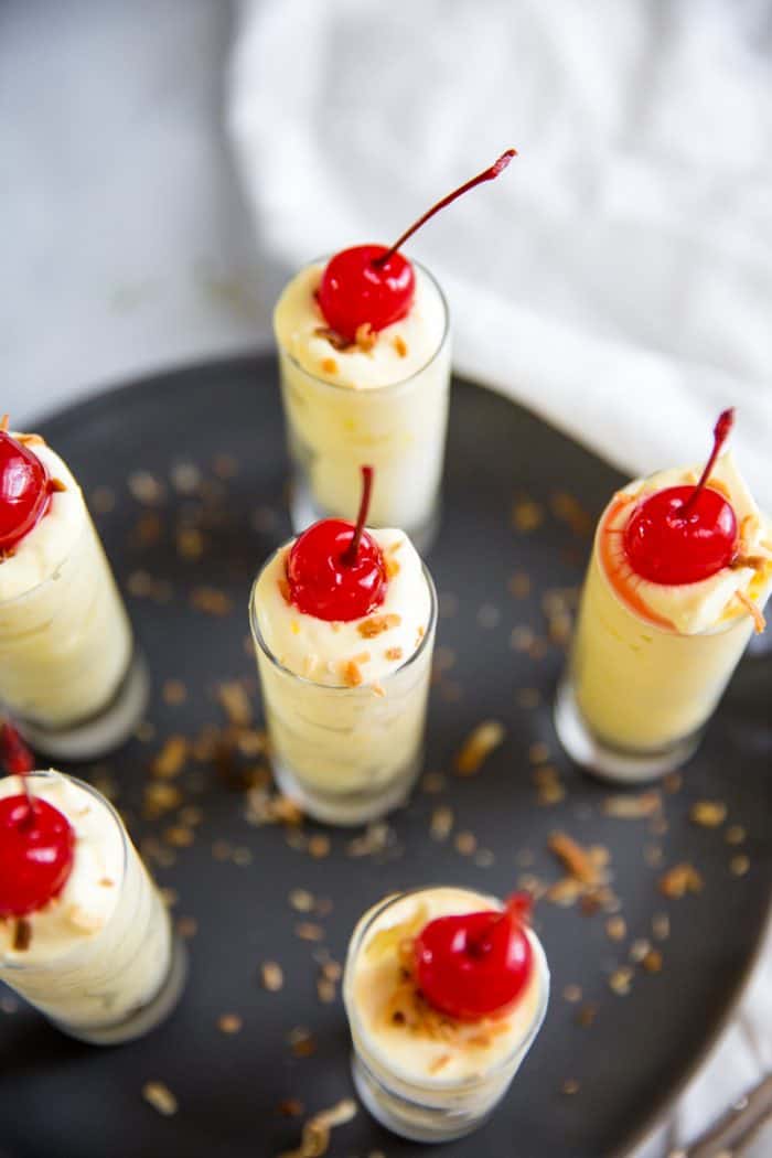 Pina Colada pudding shots with a cherry
