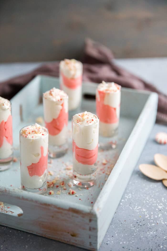candy cane pudding shots on blue tray