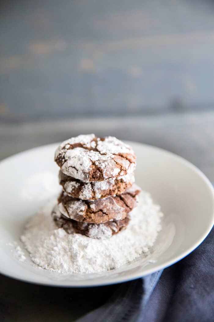 crinkle cookies on a plate of powdered sugar