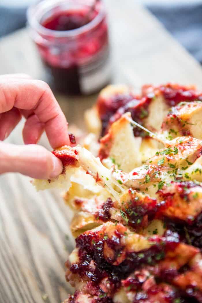 baked brie and jam bread piece being pulled