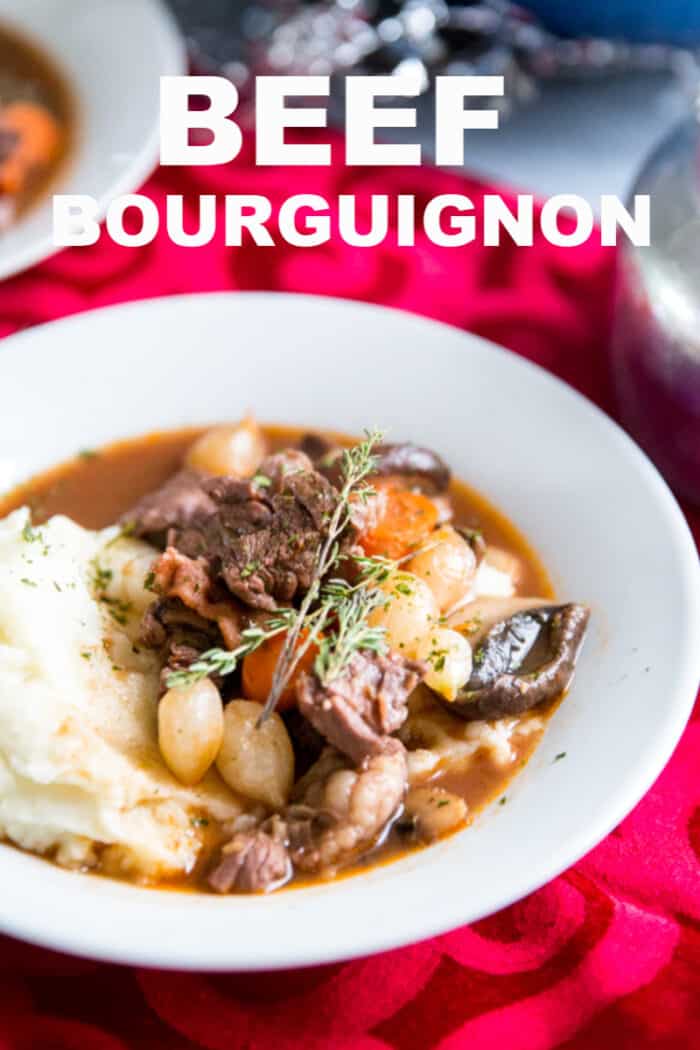 A bowl of food on a plate, with Beef and Beef bourguignon