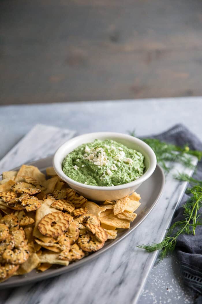 A bowl of food on a table, with Spinach dip