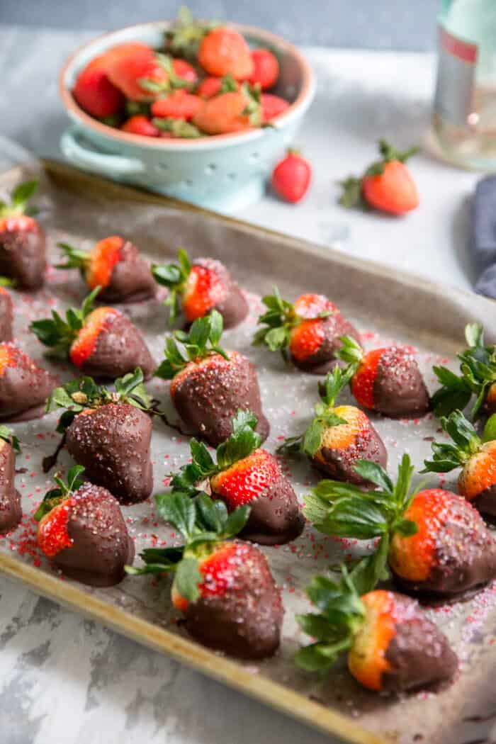 chocolate covered berries on a baking sheet