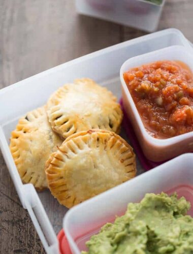 A box filled with different types of food and taco hand pies