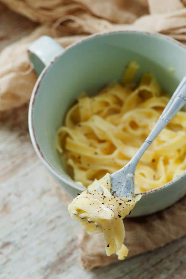 A bowl of food on a plate, with Noodle and Dinner