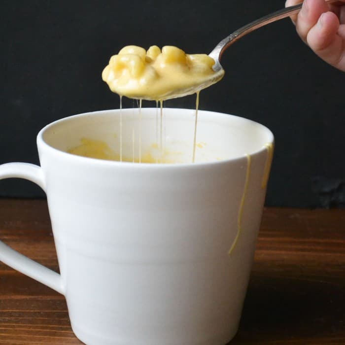 A coffee mug filled with mac and cheese