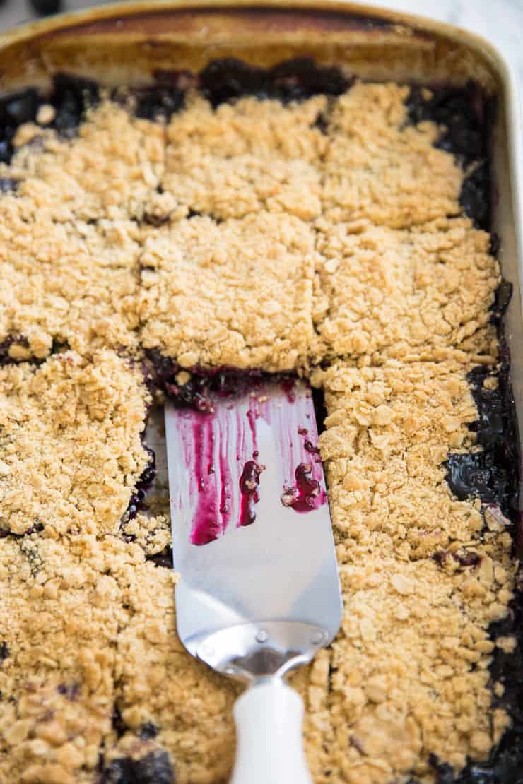 blueberry oatmeal bars with a spatula in the center