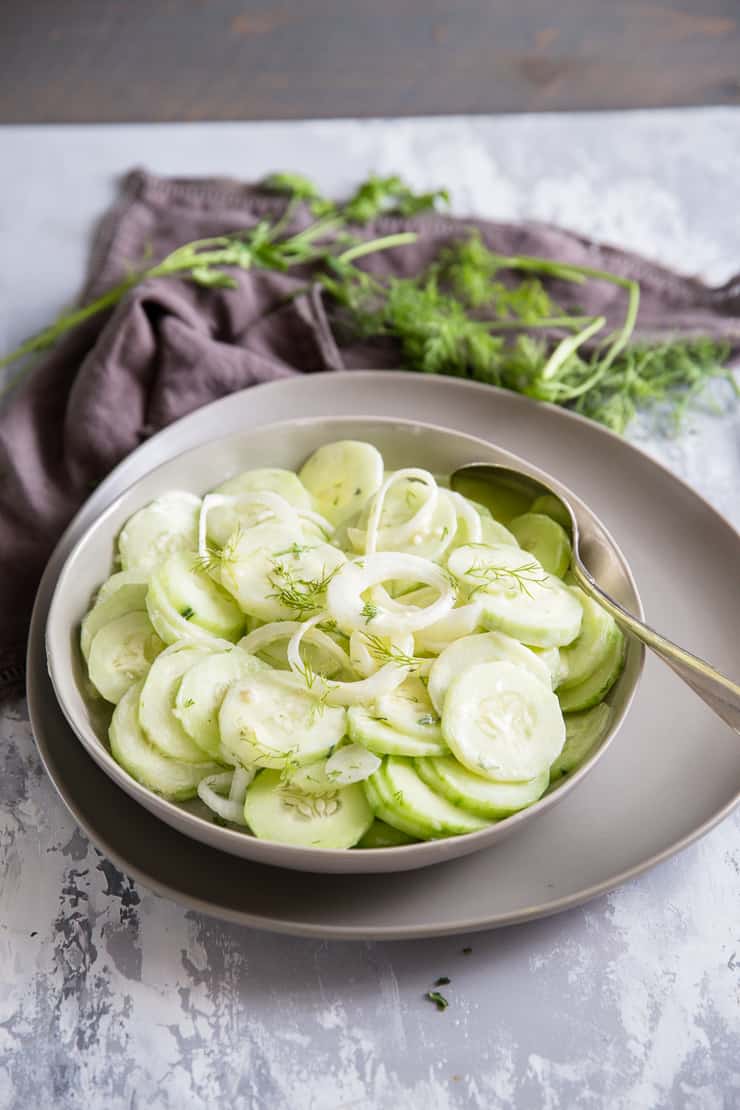 cucumber salad in a bowl set on a plate