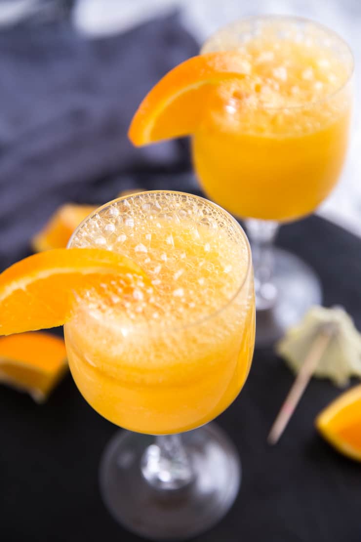 mimosa drink with bubbles and an orange slice