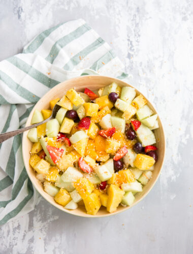 fruit salad bowl with a spoon on the side