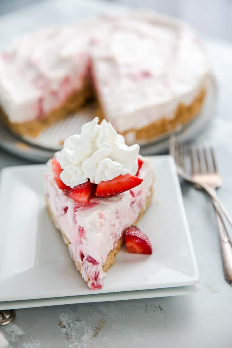 slice of strawberry cheesecake on a white plate