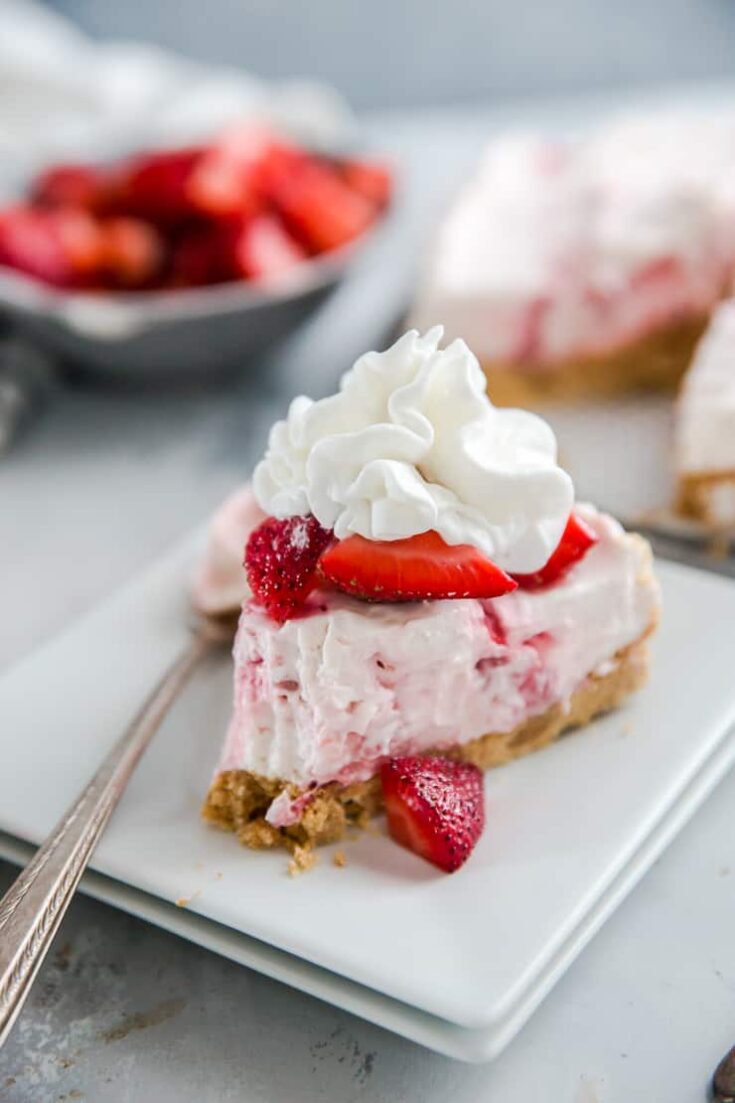cheesecake with strawberries and whipped cream on top