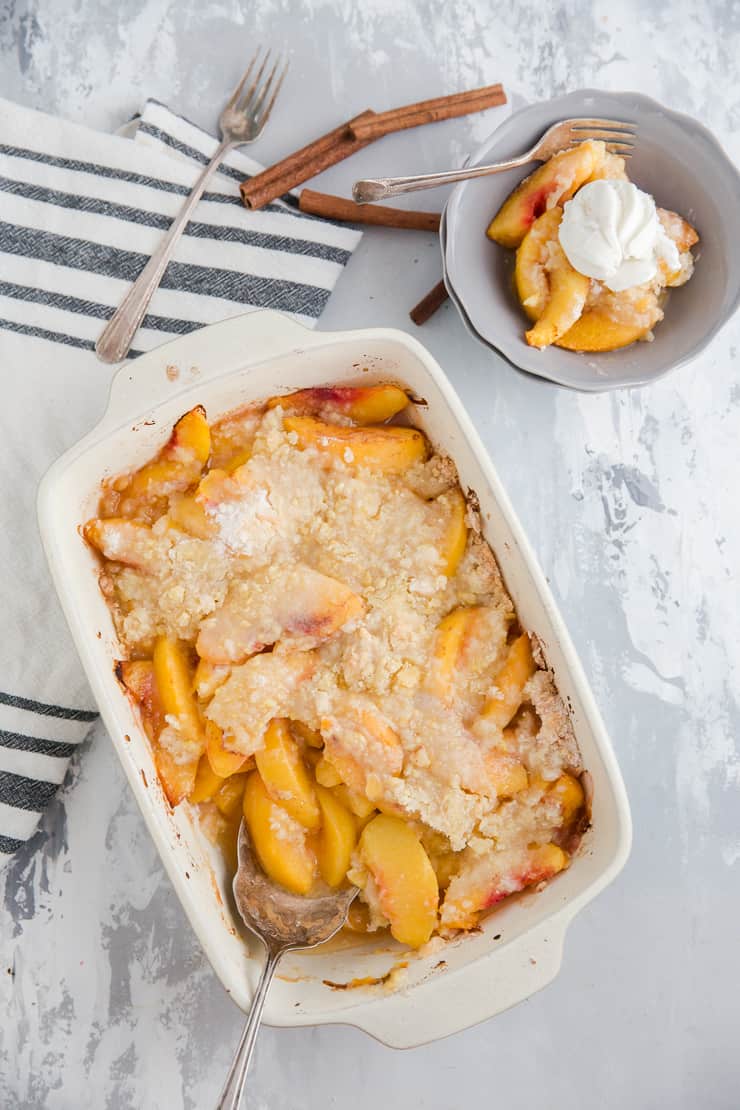 peach cobbler dip with a bowl served on the side