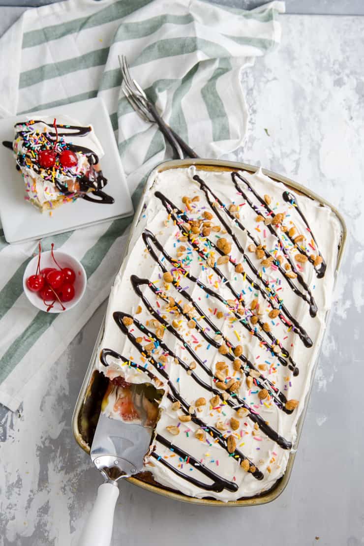 banana split cake with a slice served on the side of the pan