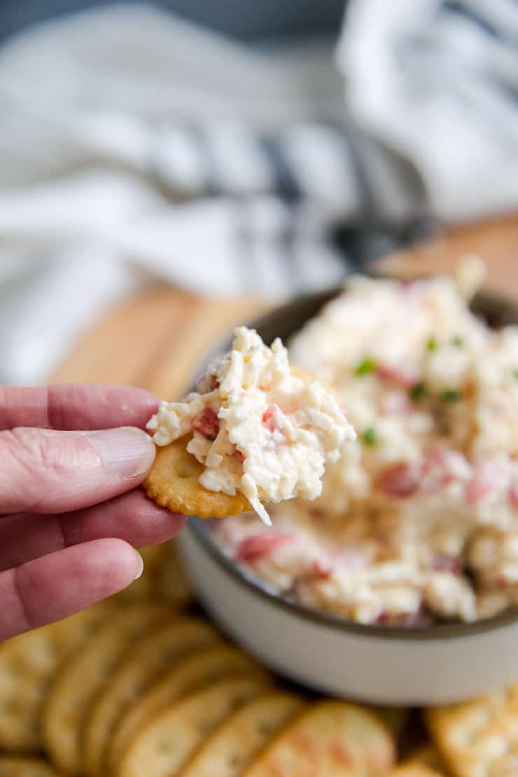 pimento cheese held up on a cracker