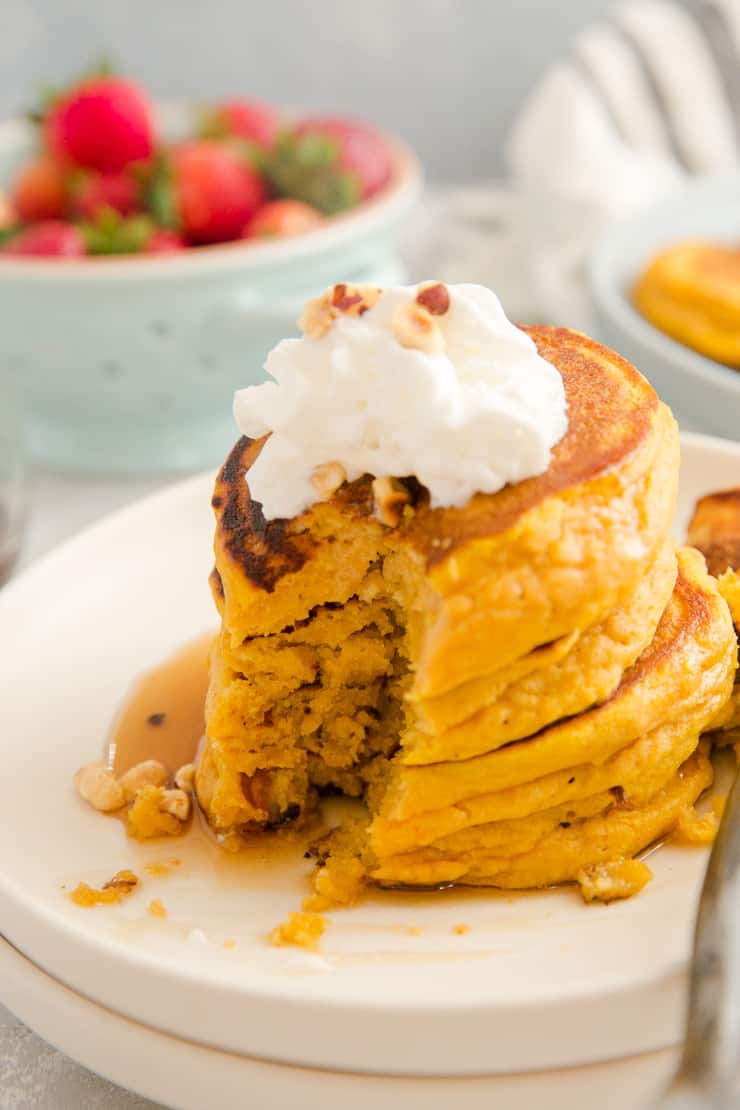 stack of pumpkin pancakes with a bite out