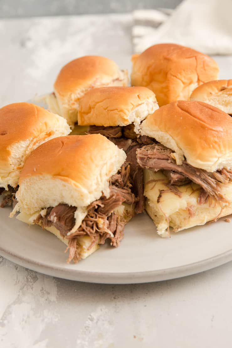 mini French dip sandwiches on a plate