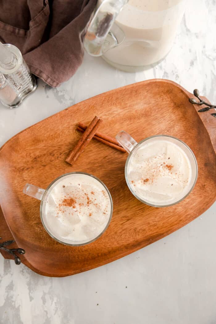 two glasses of coquito with nutmeg