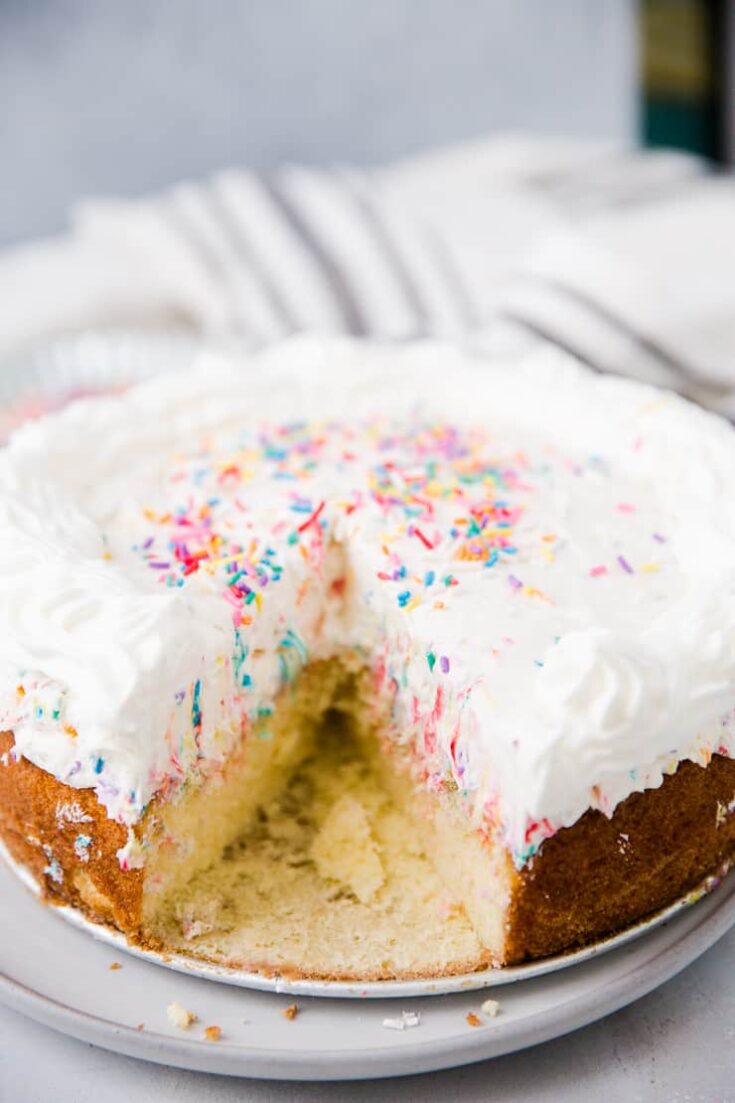 cheesecake funfetti cake with a slice missing