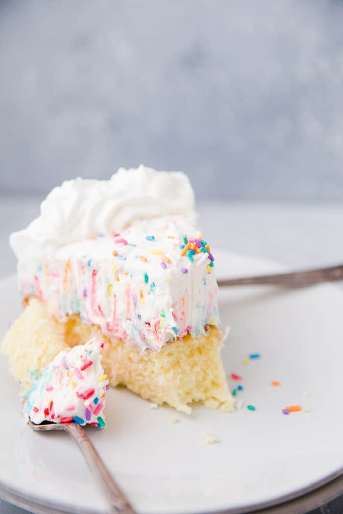 slice of funfetti cake with a bite on a fork