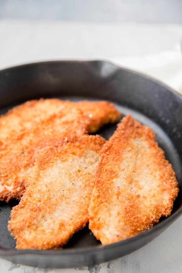 catfish fillets in an iron skillet
