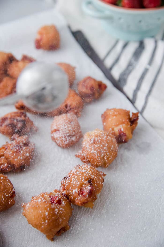 powdered sugar over fritters