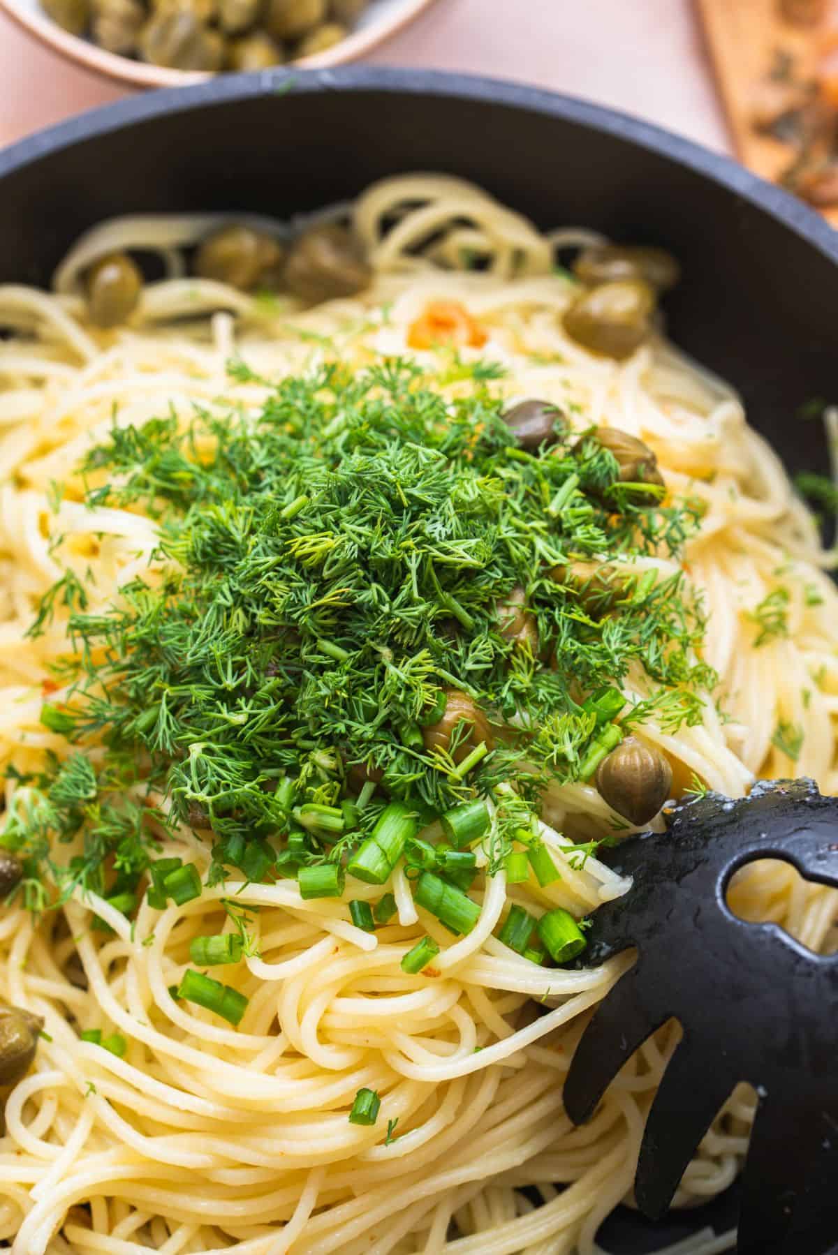 herbs on pasta in pan