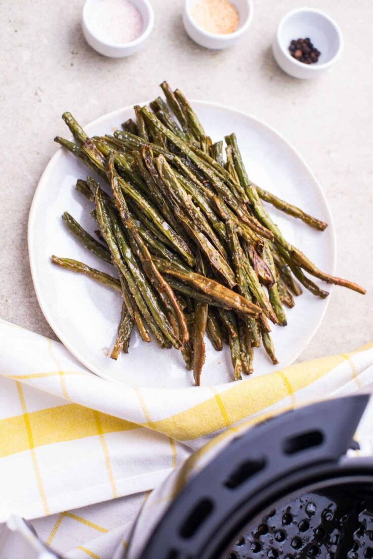 cooked Air fryer green beans on a white plate