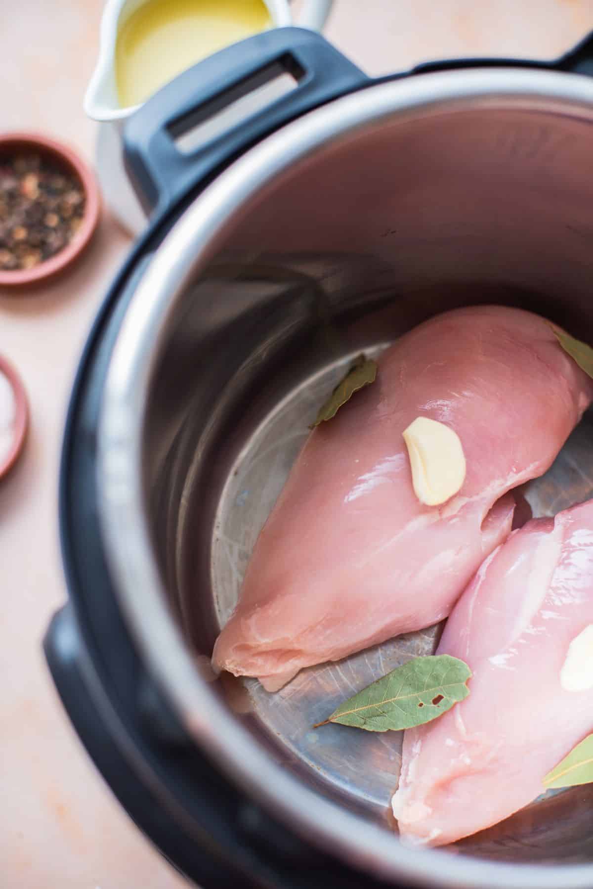 chicken breasts and ingredients in pot