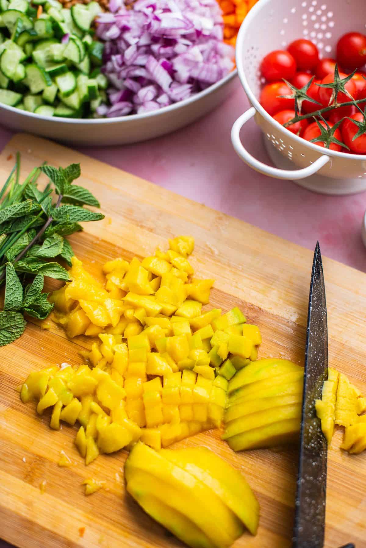 chopped mango on cutting board