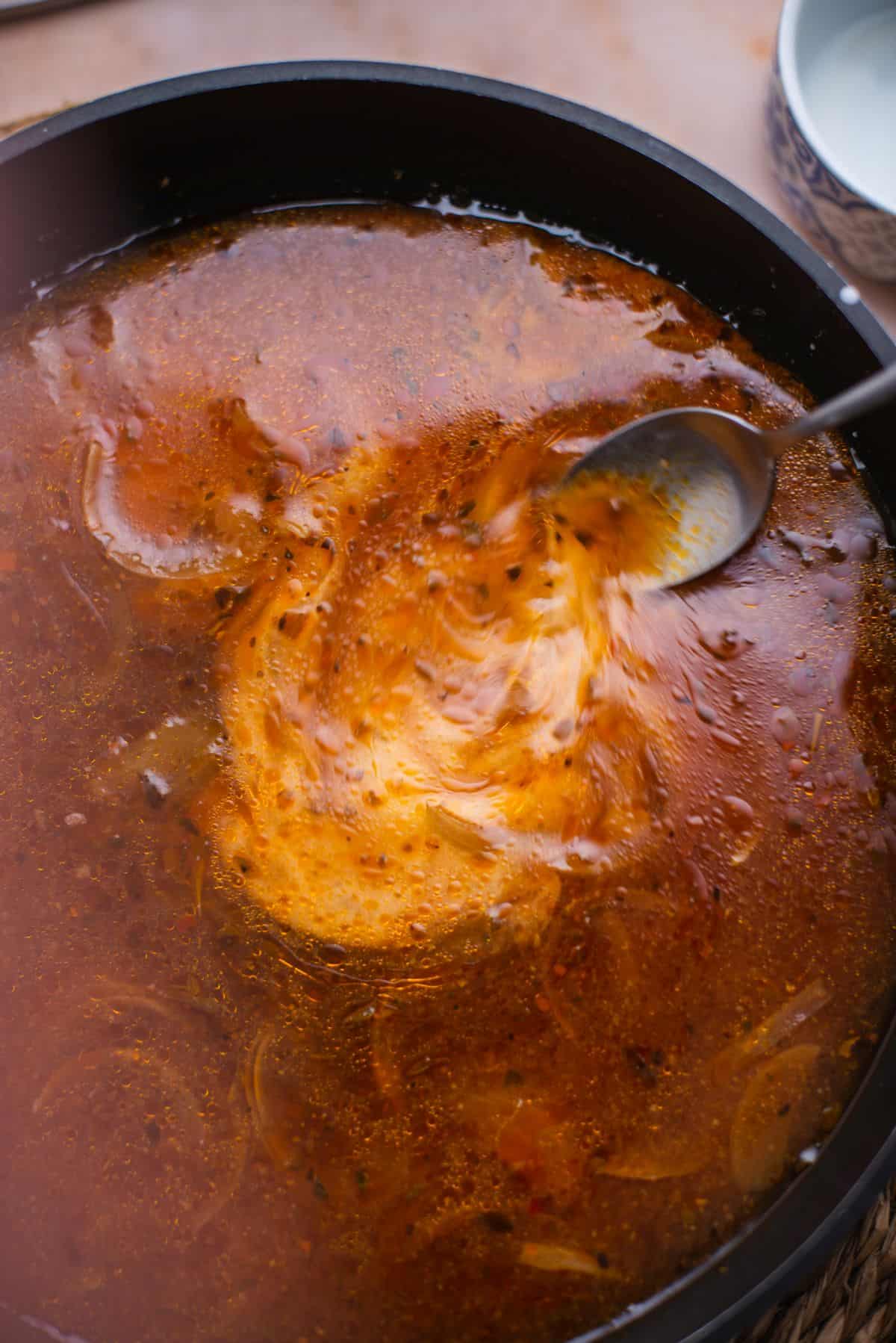 gravy in crock pot with spoon