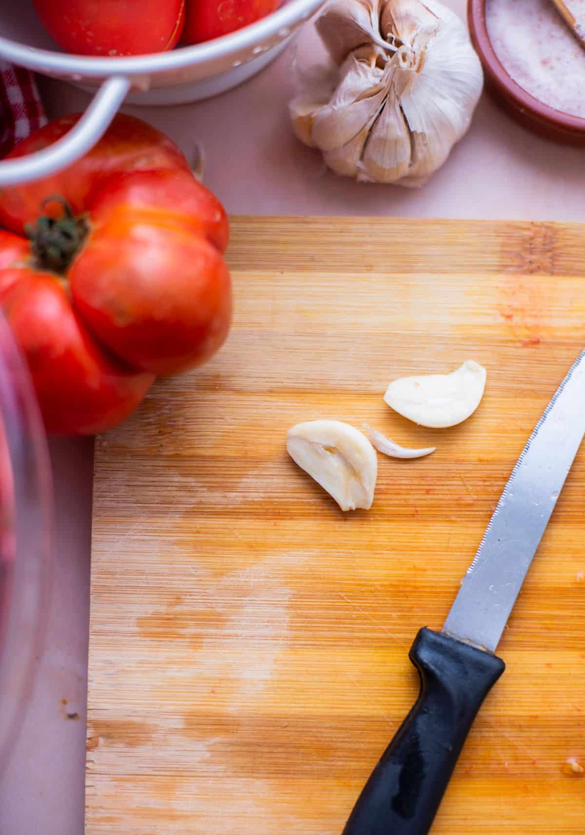 knife with garlic sliced in half